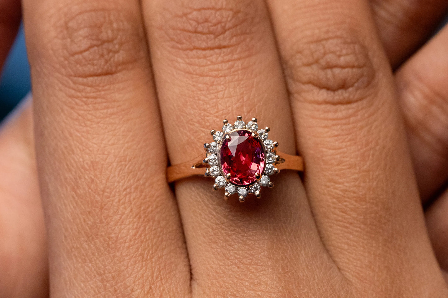 Close-up of a 1.32ct unheated Ceylon Padparadscha sapphire ring, encircled by 0.22ct diamonds, creating a rare and elegant design.