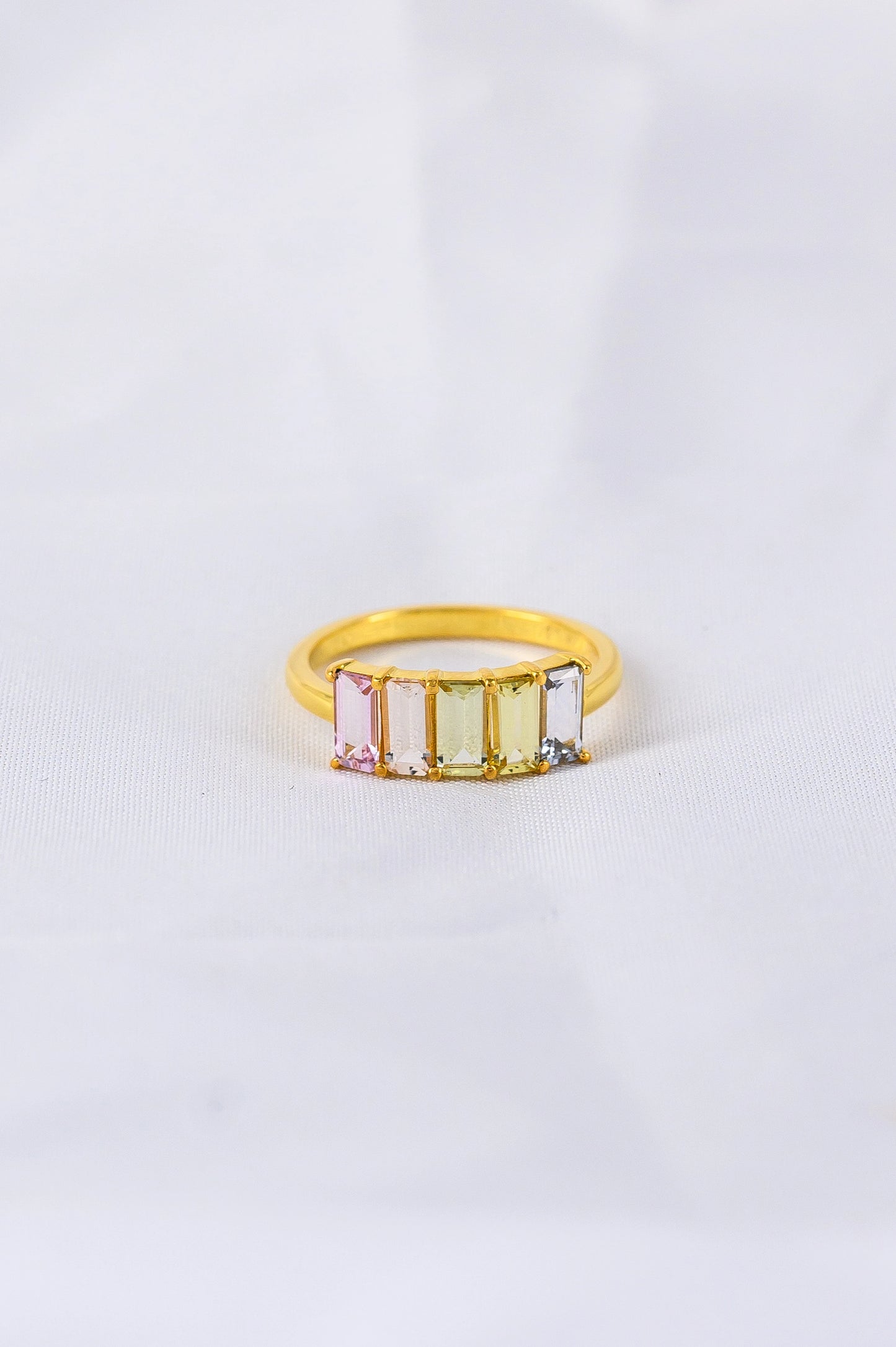 Bespoke anniversary ring crafted with soft pastel sapphires, a personal and meaningful celebration of love and enduring connection.