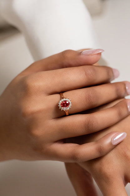 Exquisite 18K gold engagement ring featuring a 1.32ct unheated Ceylon Padparadscha sapphire, surrounded by a delicate diamond cluster for a timeless, elegant design.