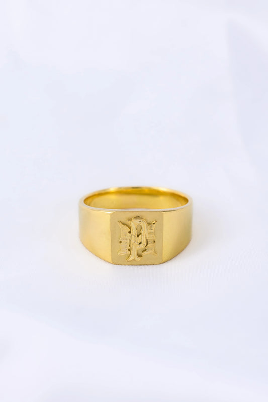 Custom 18K gold signet ring with personalized pattern, crafted to reflect heritage and boldness, a timeless family heirloom.