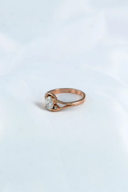 Custom rose gold engagement ring with oval diamond trio, thoughtfully crafted to celebrate a couple’s love story.