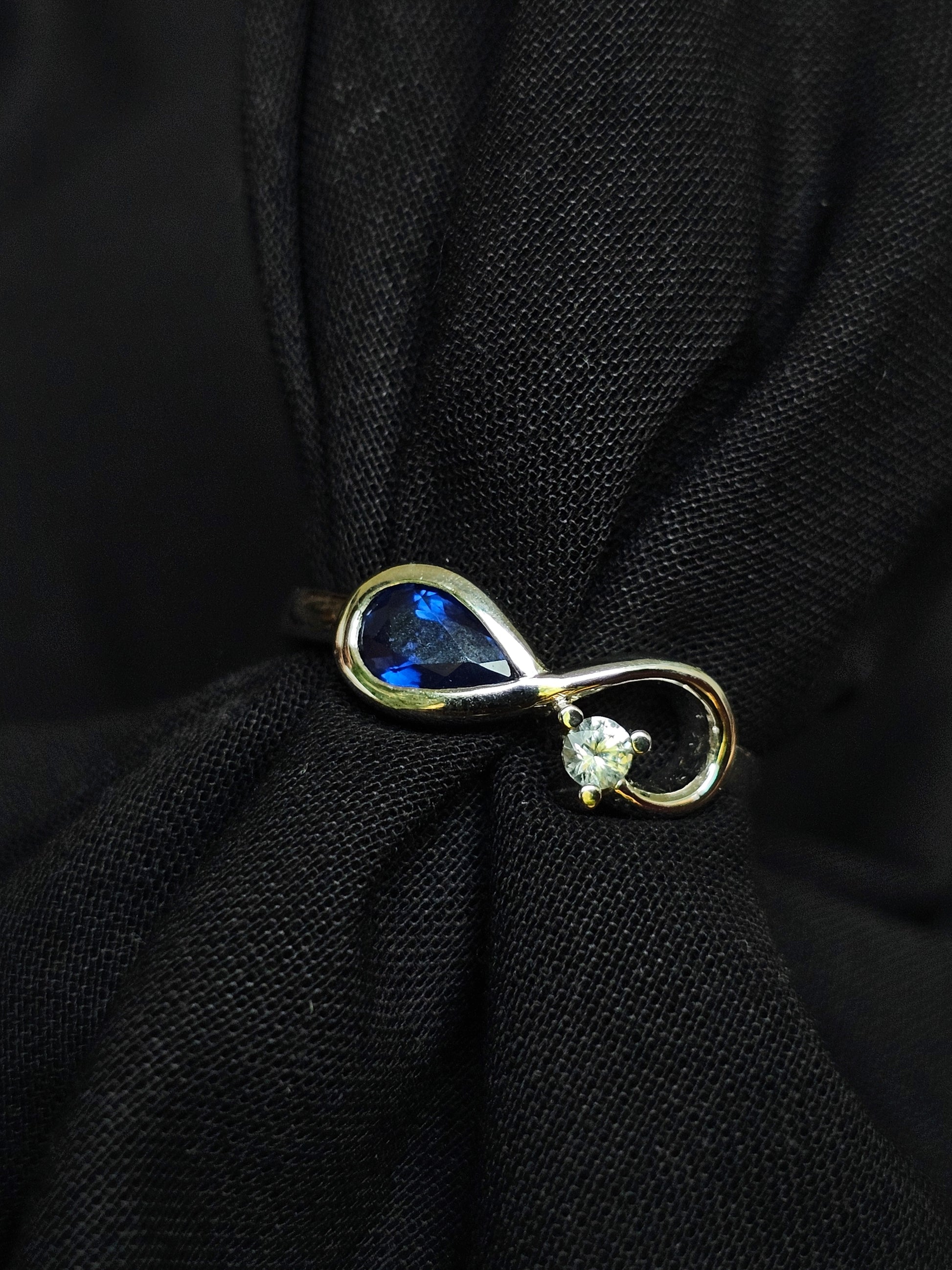 Infinity ring crafted in gold with repurposed gemstones from a sentimental engagement ring, made for everyday elegance.