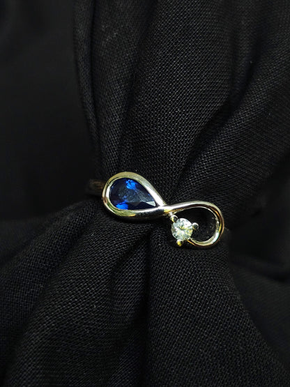 Infinity ring crafted in gold with repurposed gemstones from a sentimental engagement ring, made for everyday elegance.