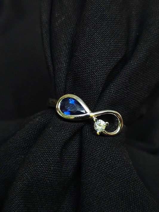 Infinity ring crafted in gold with repurposed gemstones from a sentimental engagement ring, made for everyday elegance.