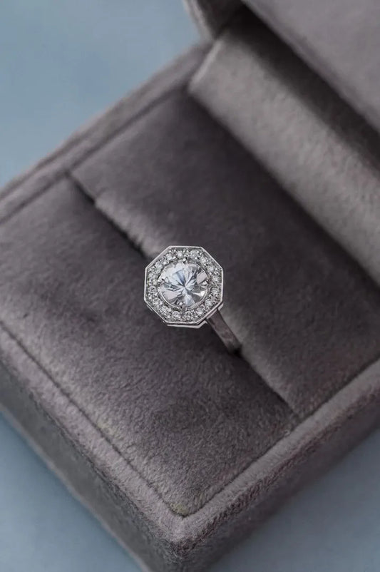 Custom engagement ring with unheated 1.18ct white sapphire and pavé-set diamonds, designed for a wedding anniversary.