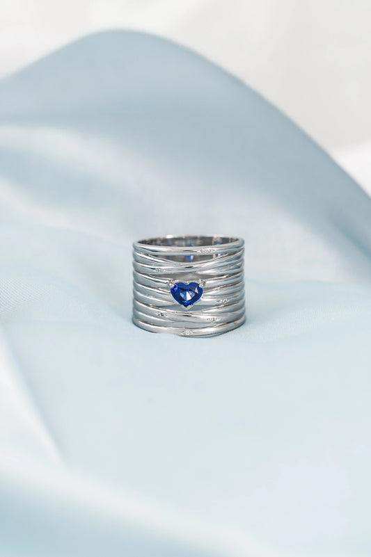 Custom-made 18K white gold ring featuring a heart-shaped Royal Blue Sapphire from Sri Lanka, accented with delicate diamonds, a meaningful gift crafted with love and care.